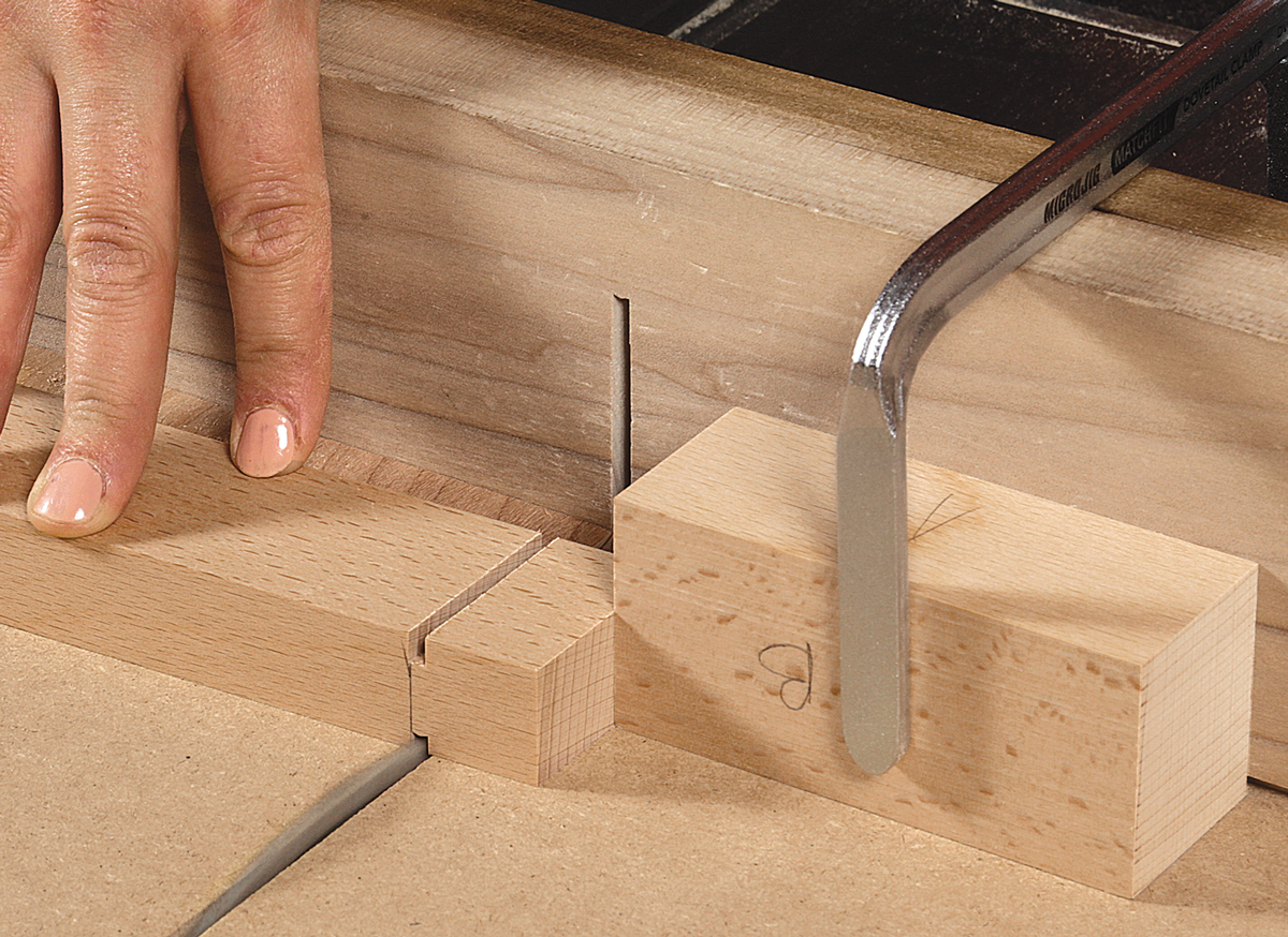 After cutting the first shoulder, transfer the kerf to the other face with a square and knife. 